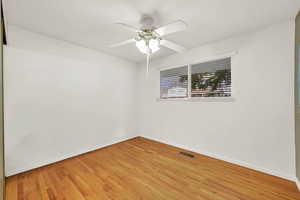 Spare room with ceiling fan and hardwood / wood-style floors