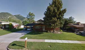 View of front of home featuring a mountain view and a front yard