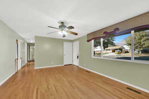 Unfurnished room featuring light wood-type flooring and ceiling fan