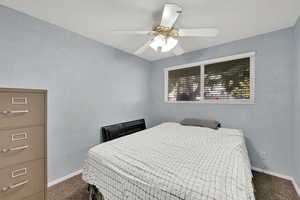 Carpeted bedroom featuring ceiling fan