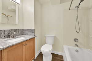 Full bathroom featuring shower / tub combination, toilet, vanity, and hardwood / wood-style flooring