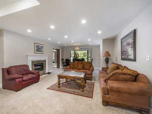 Carpeted living room with a notable chandelier