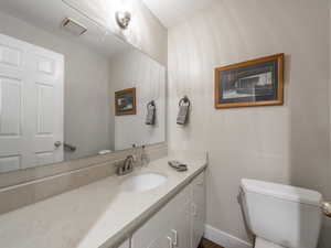 Bathroom featuring vanity and toilet