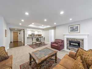 Living room featuring light carpet and a fireplace