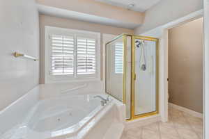 Bathroom featuring tile patterned flooring, toilet, and plus walk in shower