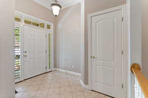 Tiled entryway with crown molding