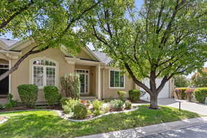 View of front facade featuring a front yard and a garage