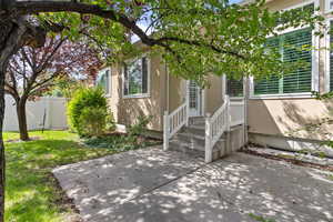 View of front of house with a patio area and a front lawn