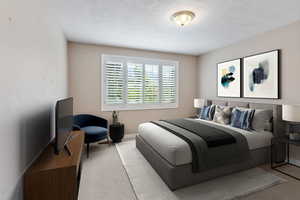 Bedroom featuring a textured ceiling and light carpet