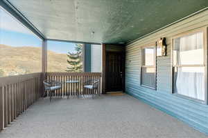 Unfurnished sunroom featuring a mountain view