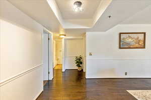 Hallway featuring dark wood-type flooring