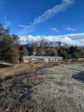 View of front of home featuring a mountain view and a rural view