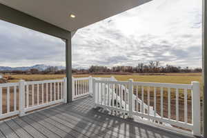 Wooden terrace featuring a mountain view and a rural view