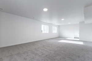 Unfurnished room featuring light colored carpet