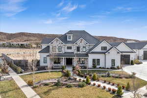 View of front of home featuring a mountain view and a front lawn