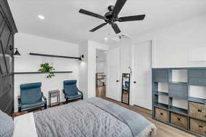 Bedroom featuring ceiling fan and light hardwood / wood-style flooring