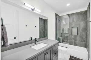 Full bathroom featuring vanity, toilet, and bath / shower combo with glass door