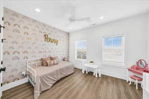 Bedroom with hardwood / wood-style flooring and ceiling fan