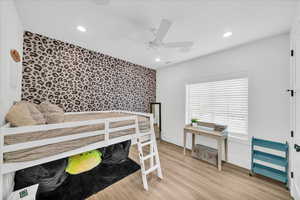 Bedroom featuring ceiling fan and light hardwood / wood-style floors