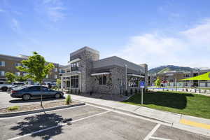 View of parking featuring a mountain view and a yard