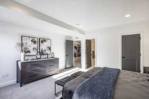 Bedroom featuring light colored carpet