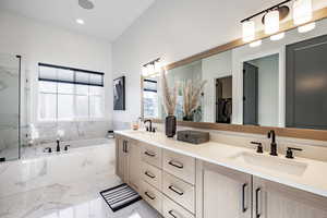 Bathroom featuring vanity and tiled tub