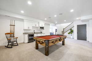 Game room featuring light carpet, wine cooler, and billiards