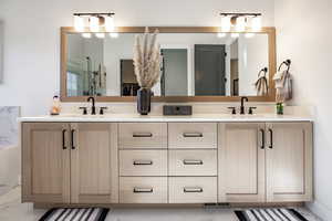 Bathroom with vanity and a shower with door