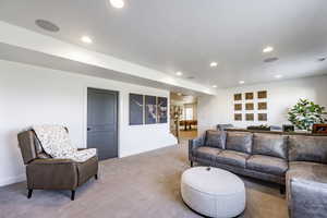 Living room with carpet flooring and a textured ceiling