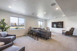 Living room with light colored carpet and a textured ceiling