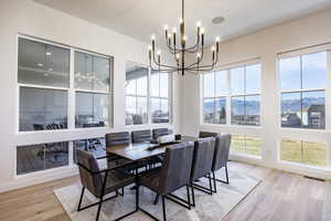 Dining room featuring a chandelier, a mountain view, and light hardwood / wood-style floors