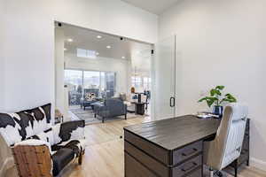 Office space featuring light hardwood / wood-style flooring and a notable chandelier