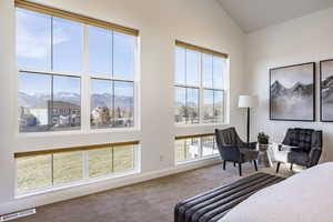 Carpeted bedroom with a mountain view and lofted ceiling