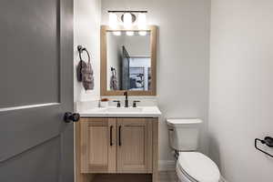 Bathroom featuring tile patterned flooring, vanity, and toilet