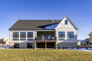 Rear view of house with a yard