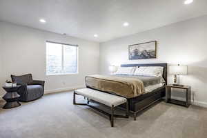 Bedroom featuring light carpet