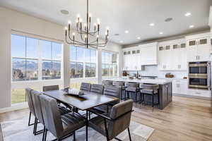 Dining area featuring a mountain view, light hardwood / wood-style floors, and plenty of natural light