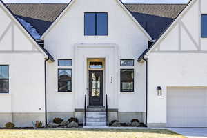 View of front facade featuring a garage