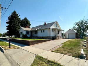 Ranch-style house with an outbuilding, a front yard, and a garage