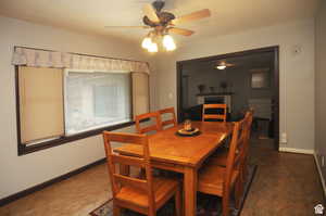 Dining room with a brick fireplace and ceiling fan