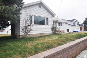 View of side of home with a lawn