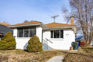 View of front of home featuring a sunroom