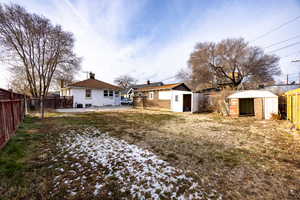 View of yard featuring a storage shed and a patio