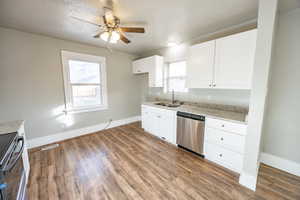 Kitchen featuring appliances with stainless steel finishes, white cabinetry, plenty of natural light, and sink