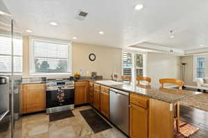 Gourmet kitchen with Granite Countertops, NEW refrigerator, NEW oven, plenty of counter space, and pantry storage