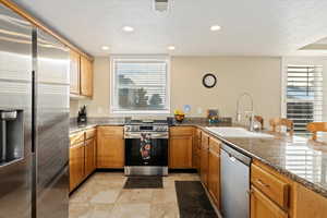 Gourmet kitchen with Granite Countertops, NEW refrigerator, NEW oven, plenty of counter space, and pantry storage