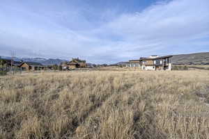 View of yard with a mountain view and a rural view