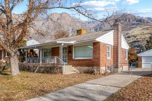 View of front of house with a mountain view and a porch