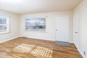 Foyer entrance with plenty of natural light and hardwood / wood-style flooring