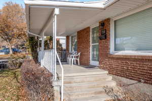 View of exterior entry with covered porch